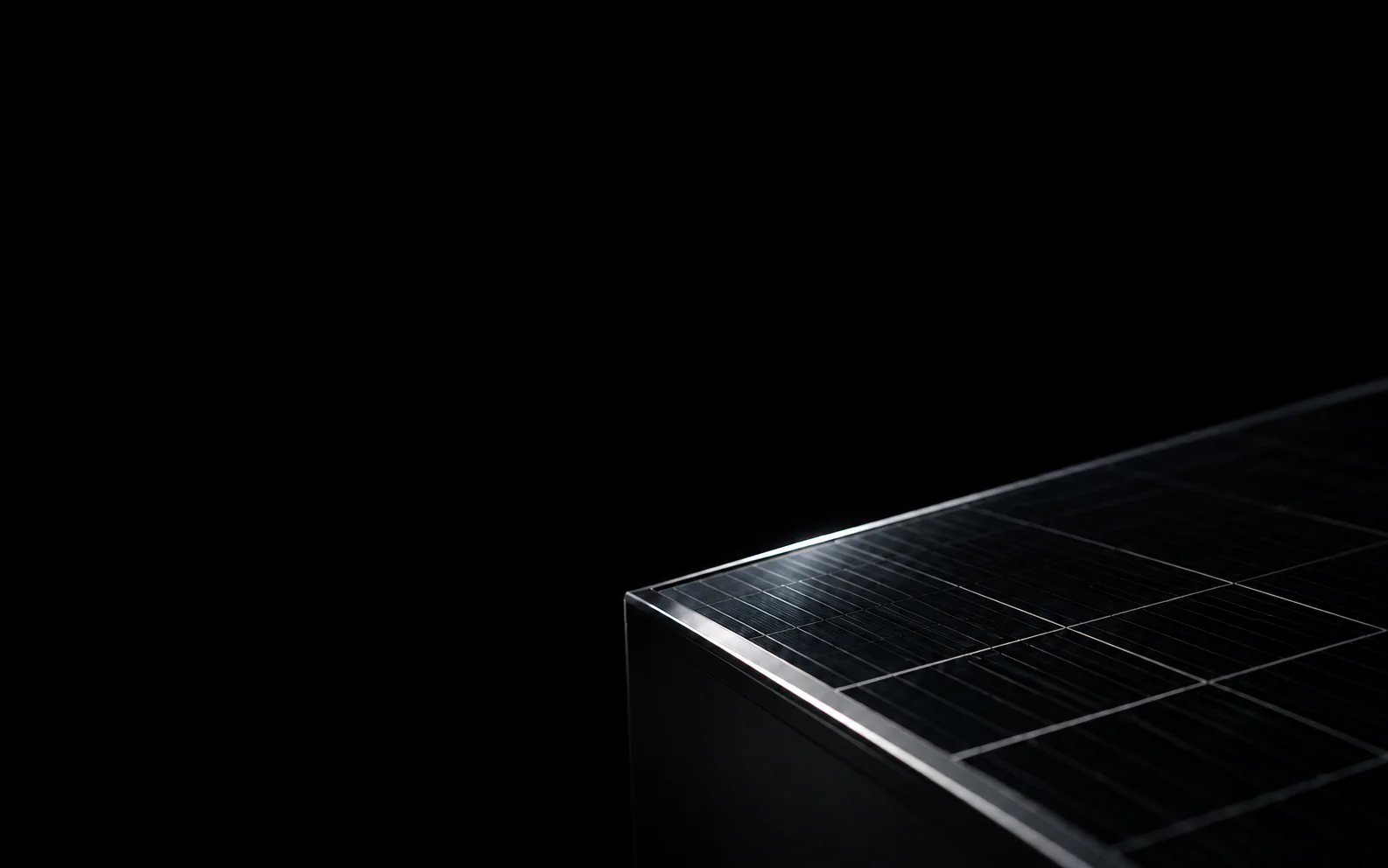 A thin silver edge catches the light across dark photovoltaic glass.